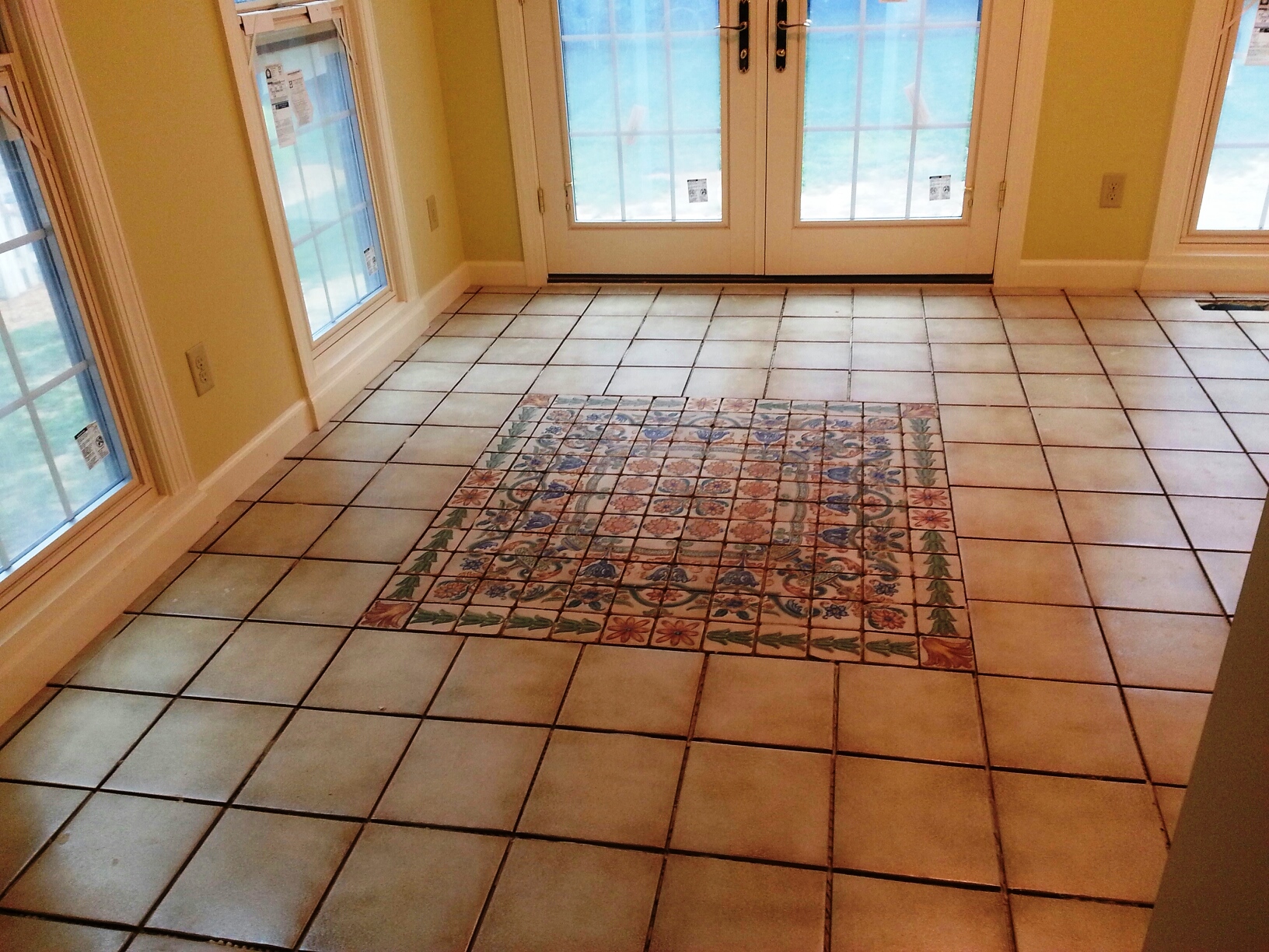 Sun room ceramic tile and ceramic hand painted mosaic are complete! Kimberly Builders