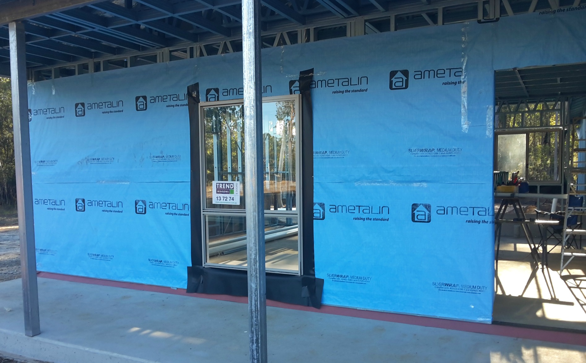 Installing vapor lock home insulation on your kit home frame walls.