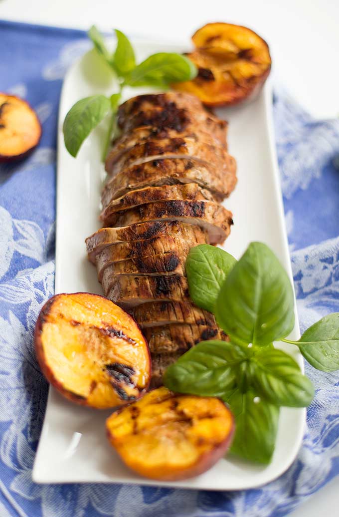 Grilled Pork with Peaches and Basil: A great way to use fresh peaches and basil, this simple marinade elevates pork with juicy, sweet flavors.