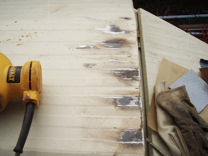 Refinishing rusty trailer grind or sand paint?