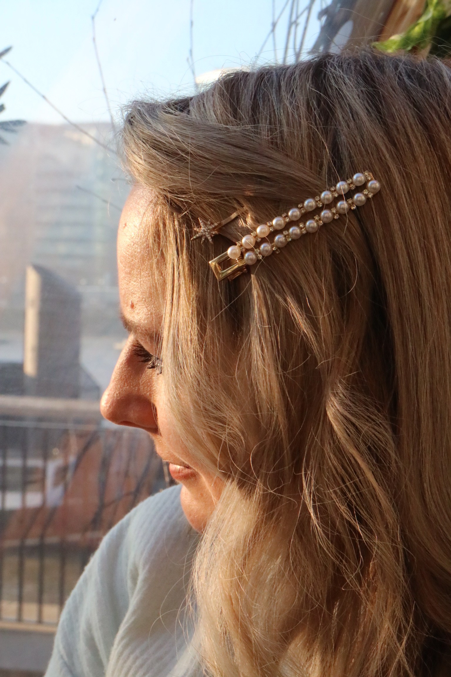 A close up of Lucy’s hair with a pearl hair slide and a star hair clip in her hair 