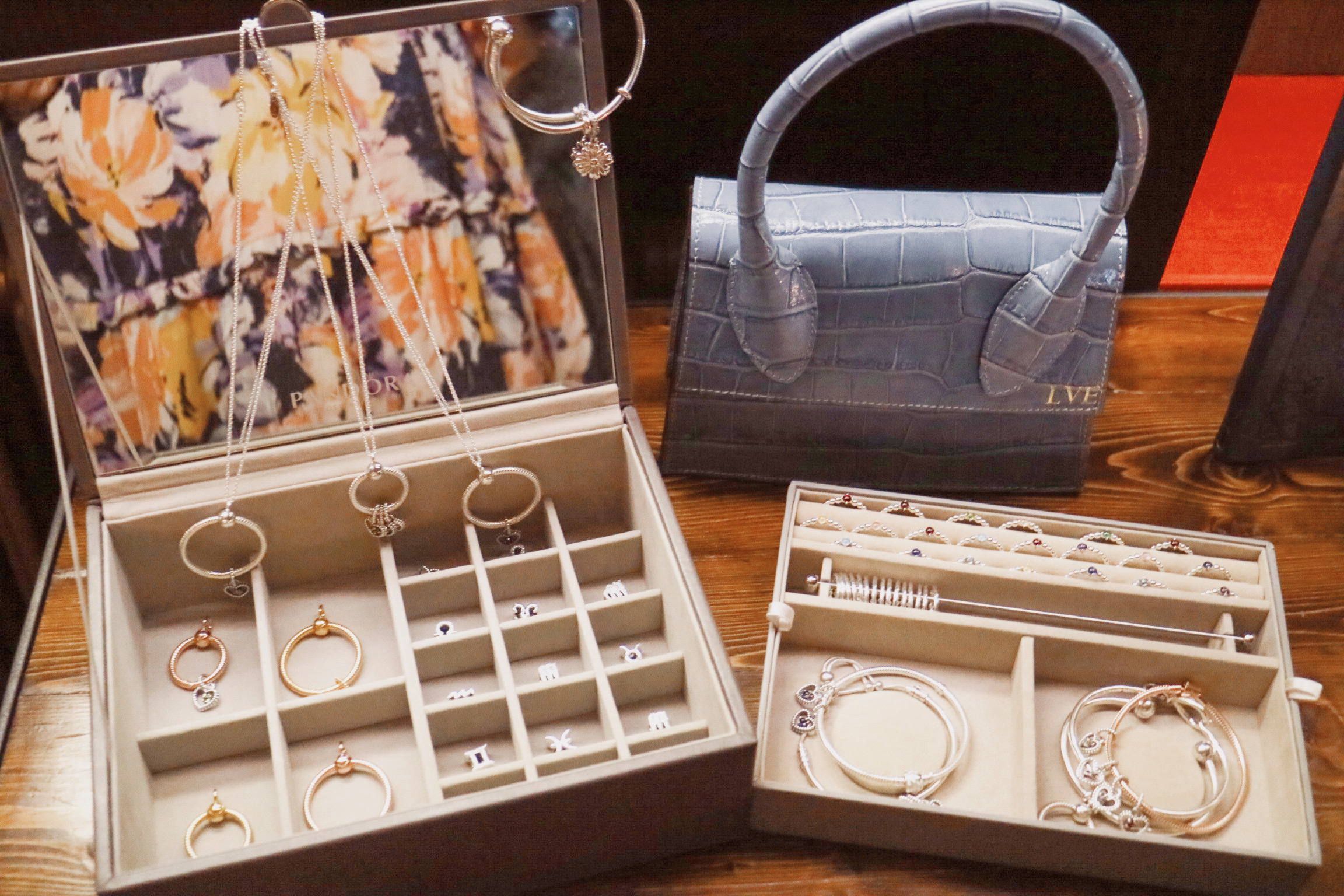 pandora charms and necklaces in a jewellery box and my azurina blue bag in the background