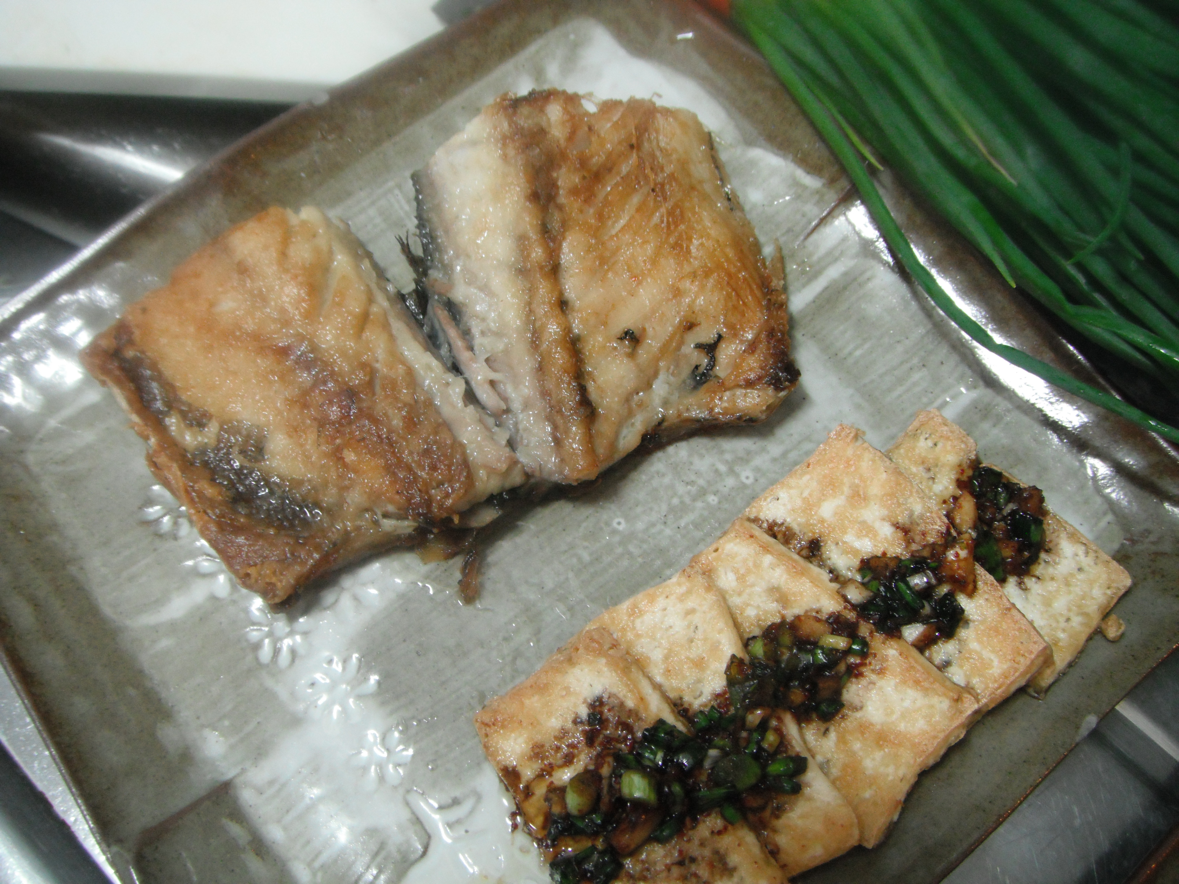 Korean food photo Pan fried tofu with spicy sauce and grilled mackerel