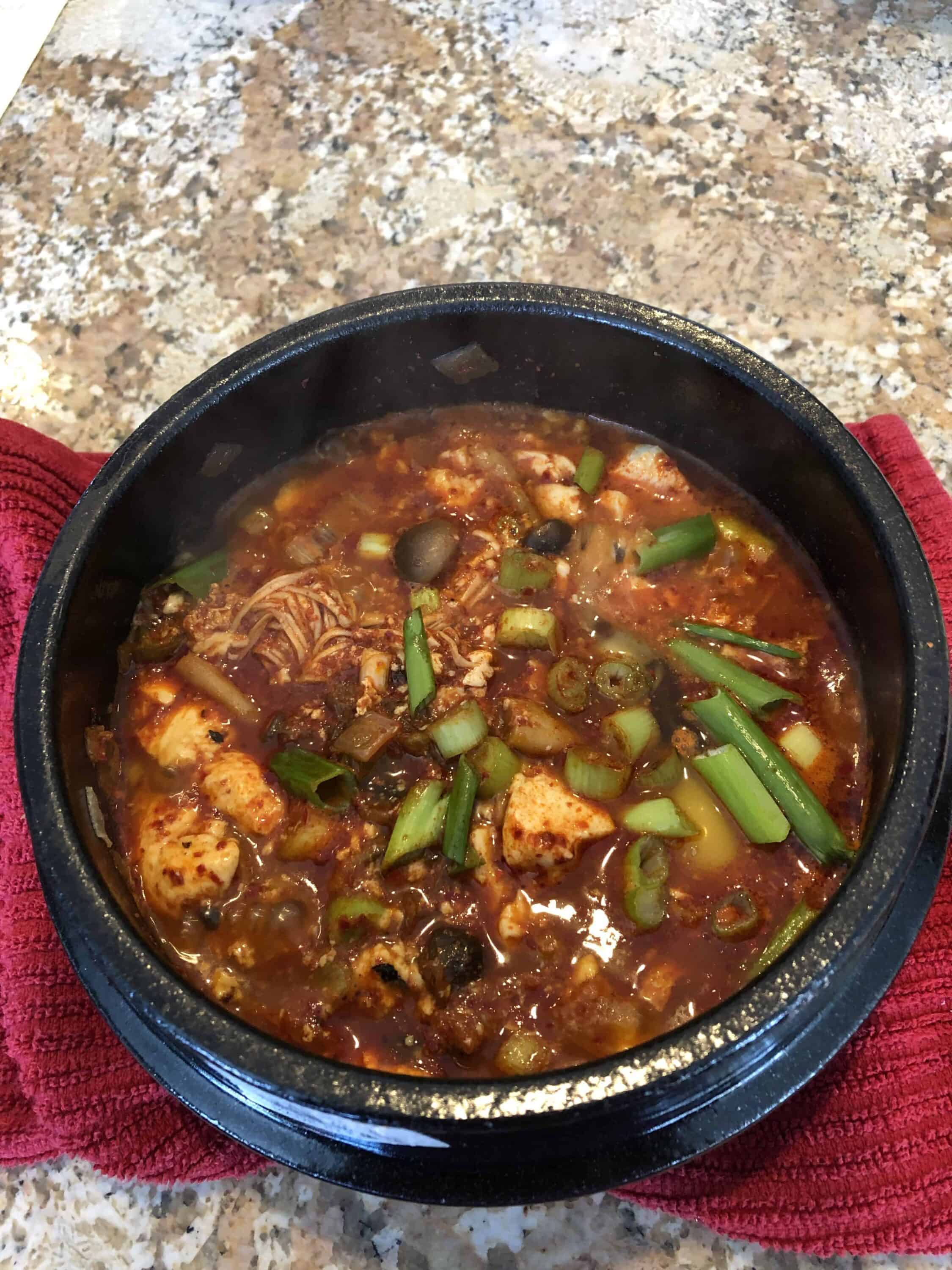 Sundubujjigae (순두부찌개) Spicy soft tofu stew with kimchi and pork belly