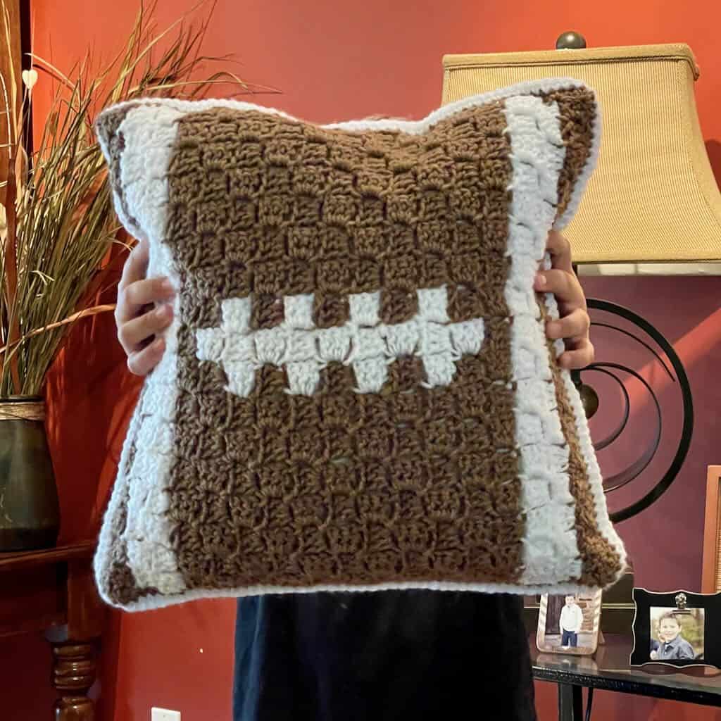 A crochet football pillow to show your team spirit MadameStitch