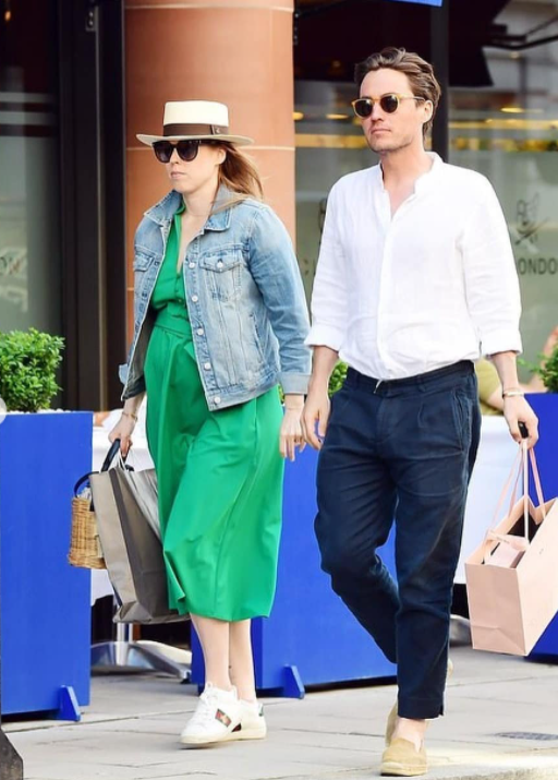 Princess Beatrice seen cradling her burgeoning baby bump with husband