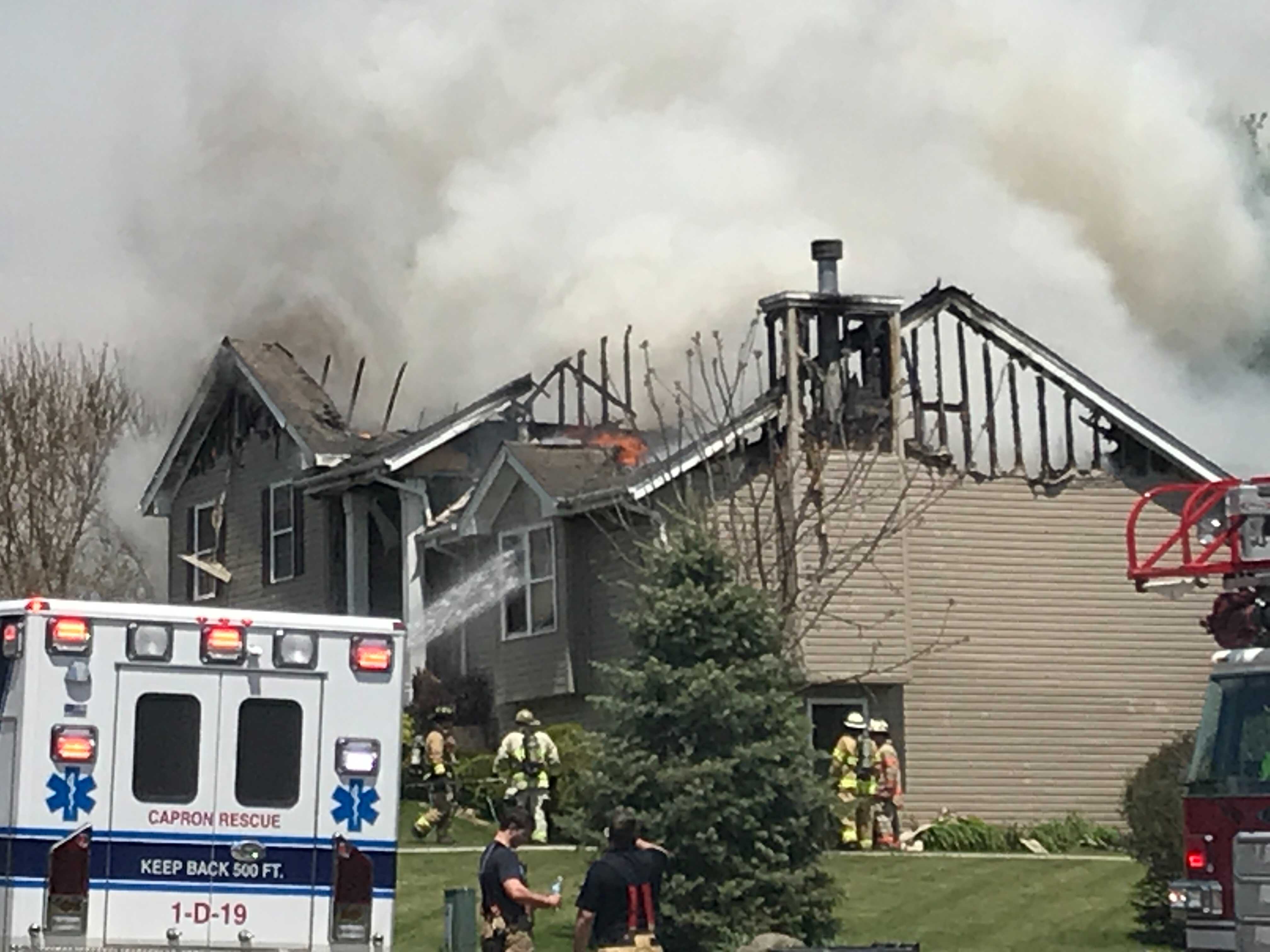 Firefighters battle 2 story house fire in Roscoe