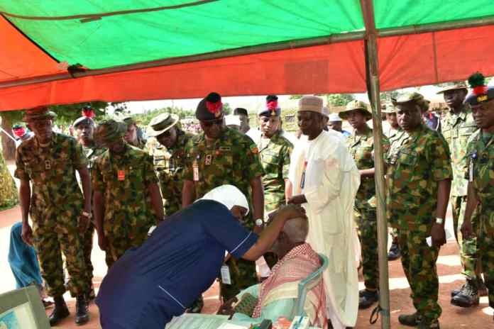 NDA officials inspecting free treatment of an elderly man by medical team at Dankande Community in Kaduna State
