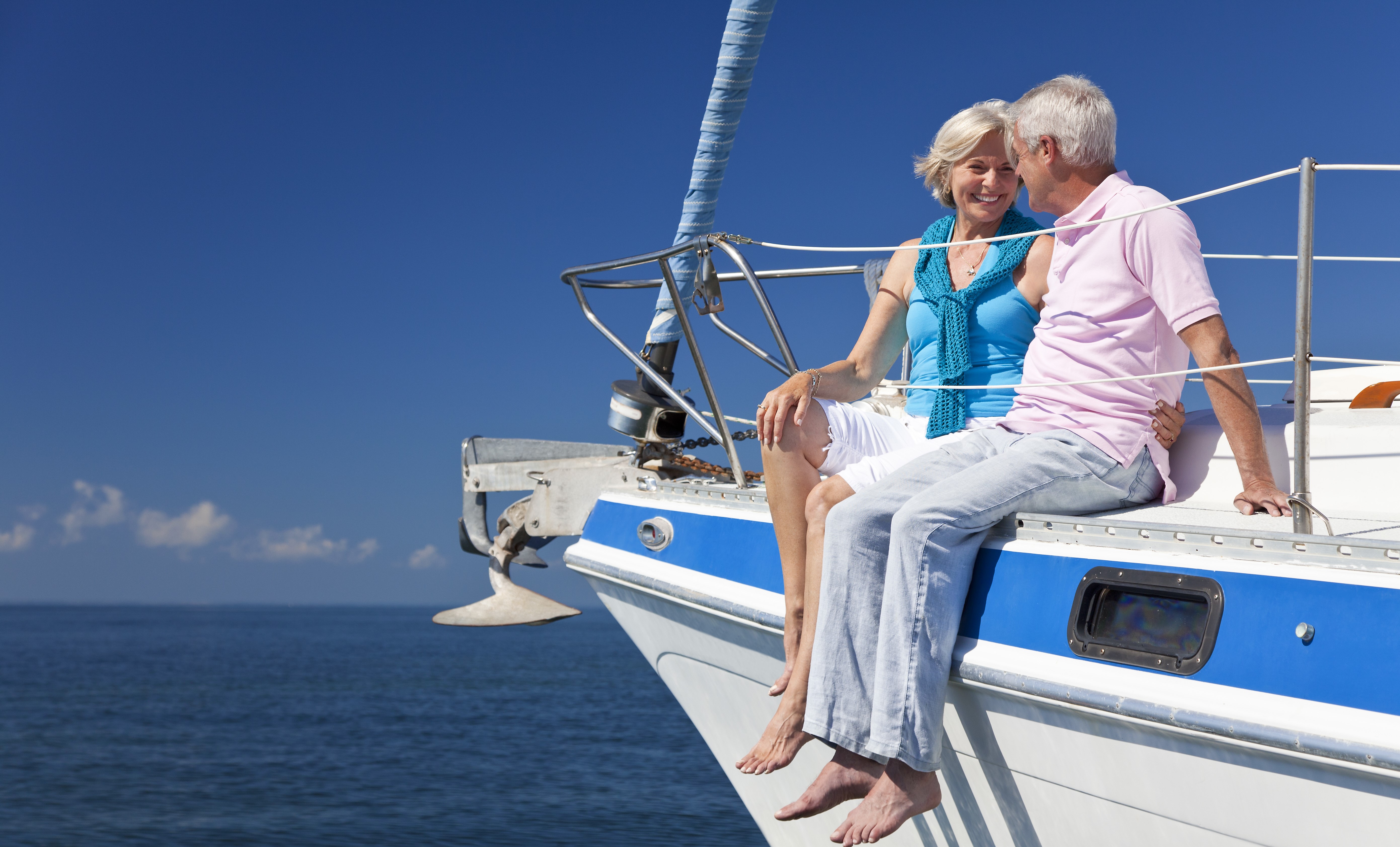 Happy Senior Couple Sitting on a Sail Boat PFG Private Wealth Management LLC