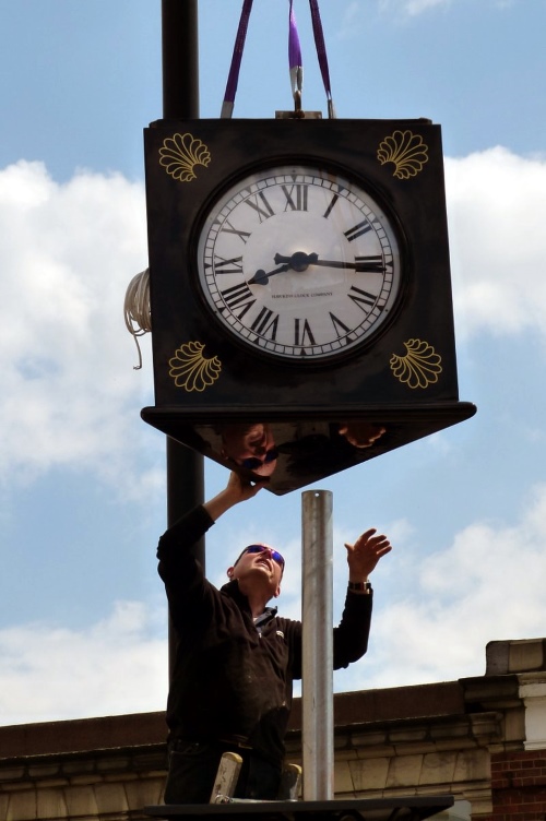 Installation of the new clock at Palmers Green Triangle Palmers Green