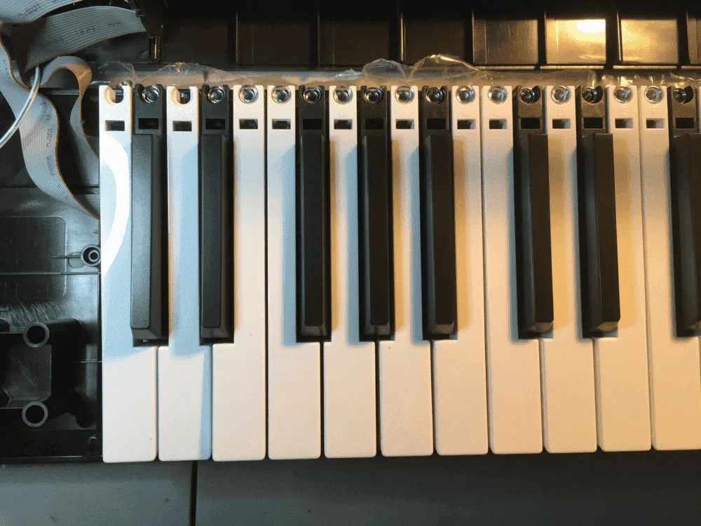 A standard piano keyboard juxtaposed with a 'balanced' keyboard