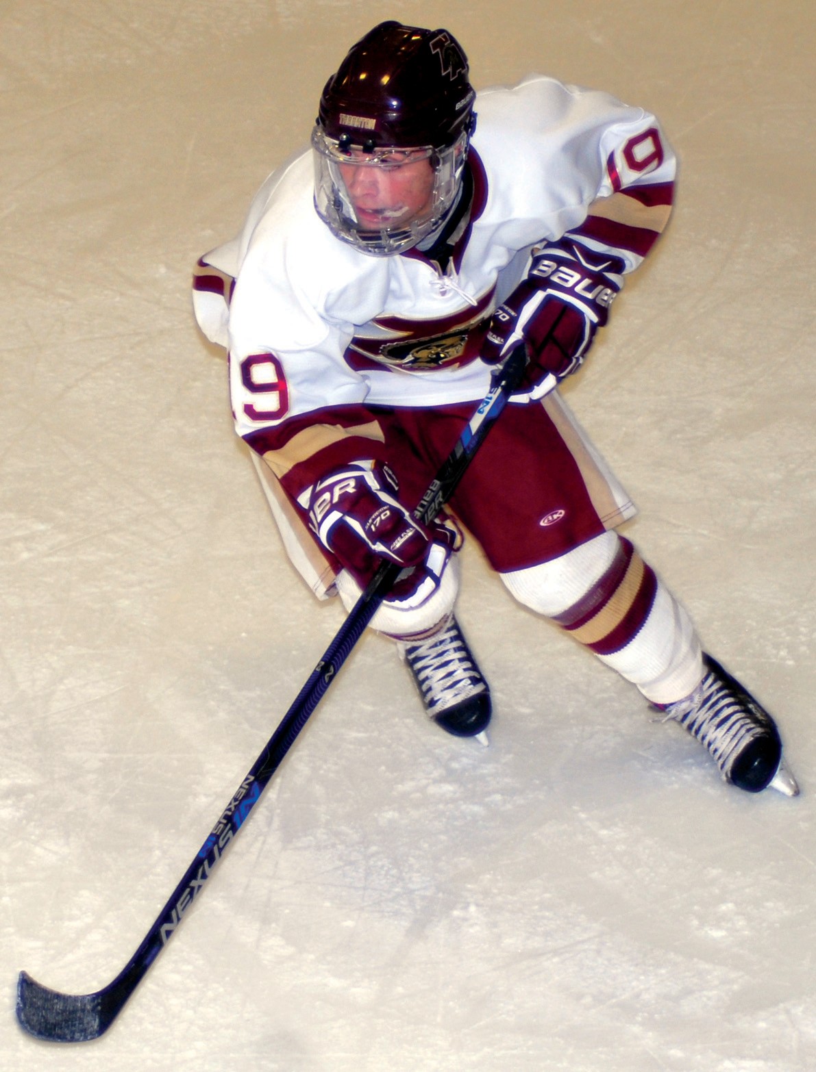 Thornton Academy’s Luke Chessie chases down the puck during Tuesday night’s Class A South quarterfinal game against Noble/Wells. Chessie was one of six players to score in the Trojans’ 6-1 win.