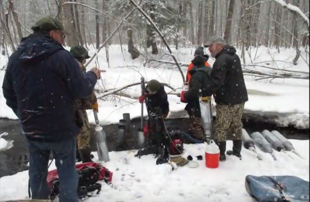 Saco Salmon Restoration Alliance members plant salmon eggs in Swan Pond Creek, which is part of the Saco River watershed.