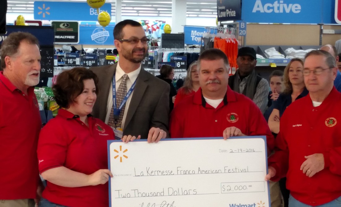 Walmart Biddeford Store Manager Mike Lilley presented checks to Ducks Unlimited, left, and the La Kermesse Franco- Americaine Festival board of directors, right, at a recent ceremony honoring renovations to the store.