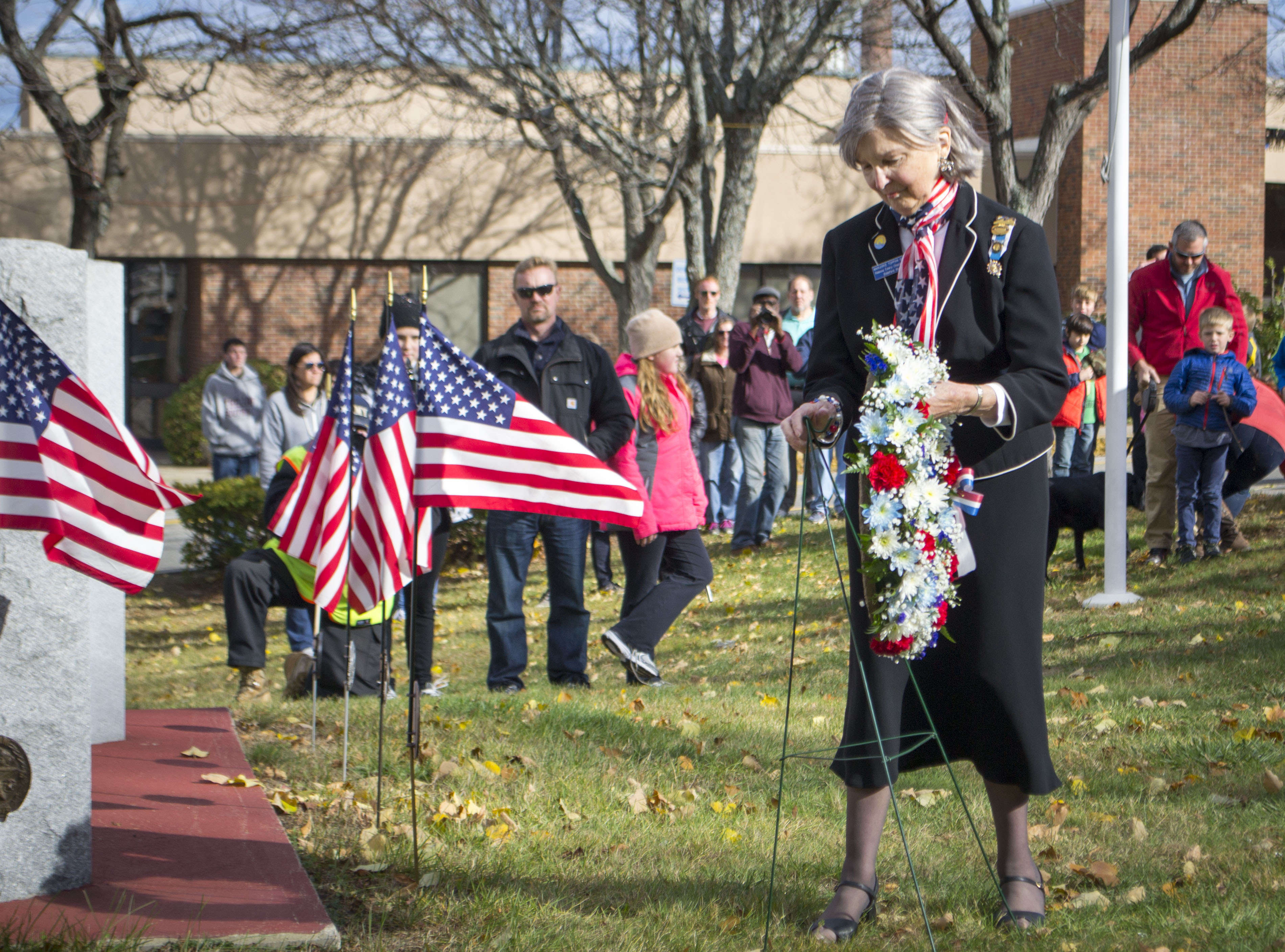 Parade Grand Marshal Marjorie Toppan Scott lays a wreath at the memorial in Biddeford’s Veterans Memorial Park during a Veterans Day ceremony on Friday. ALAN BENNETT/Journal Tribune