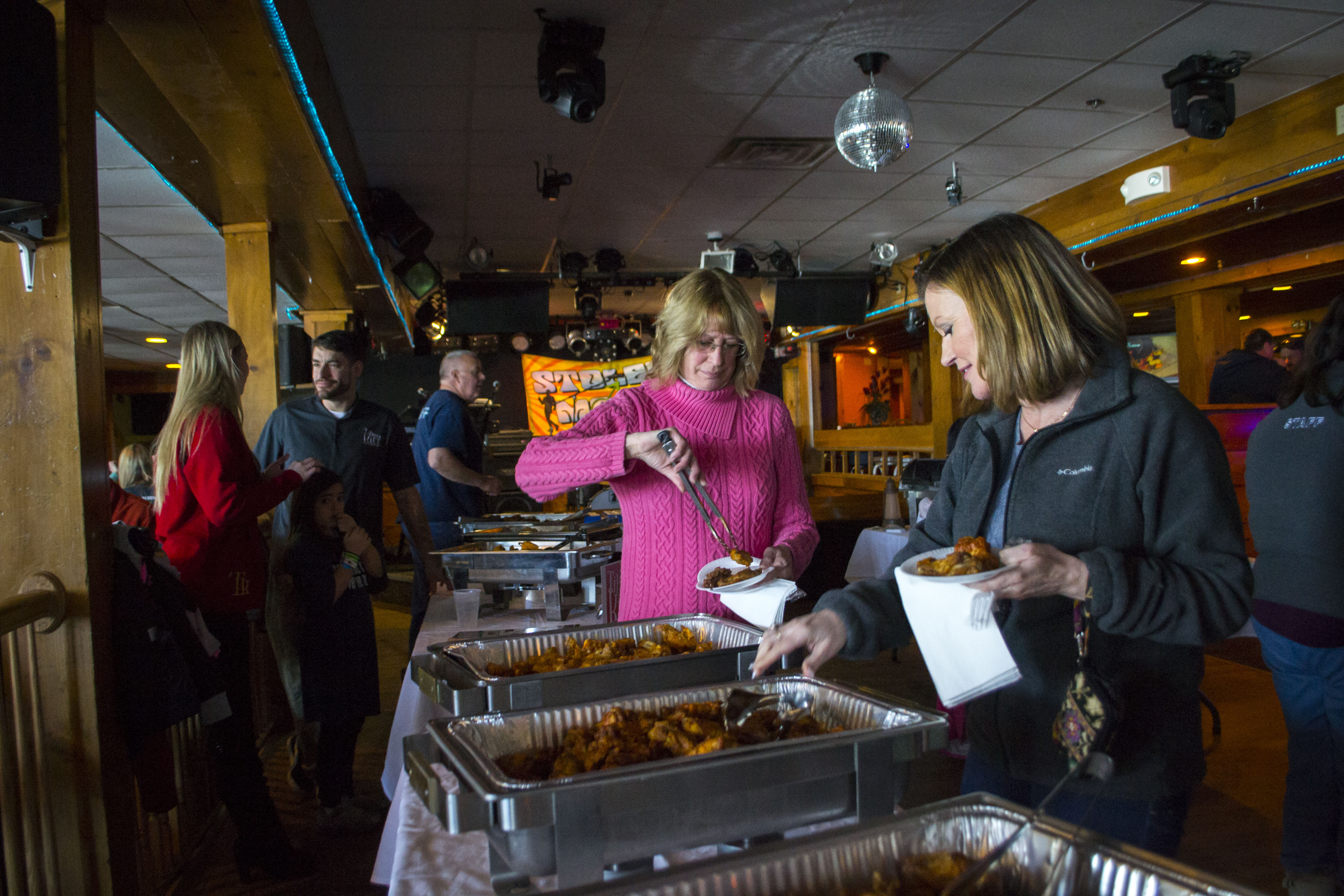 Attendees of Fire and Ice pick through an assortment of hot wings, supplied by various eateries across southern Maine, in the American Cancer Society’s second-annual event Saturday. ALAN BENNETT/Journal Tribune