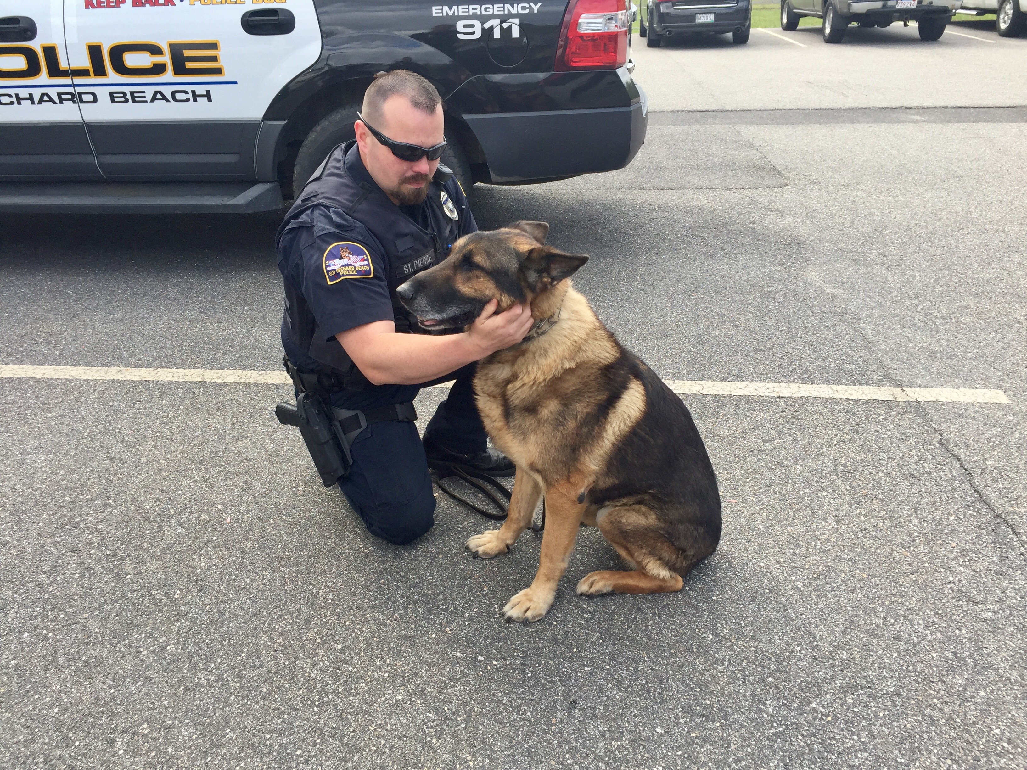 Old Orchard Beach Police Detective Chris St. Pierre sits with K-9 Gunther outside the police station on Gunther's last day on the job Saturday.LIZ GOTTHELF/Journal Tribune