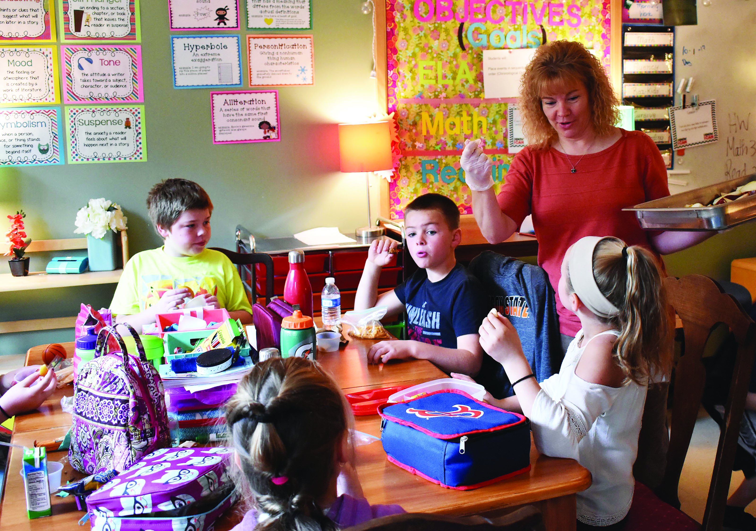 With tray in hand, Wells Ogunquit School District Nutrition Director Lisa Currie conducts a survey of students to determine their preferences among two varieties of pear. COURTESY PHOTO/Reg Bennett
