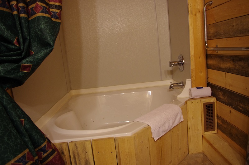 Two person jacuzzi tub built into original woodshed of Bunkhouse at