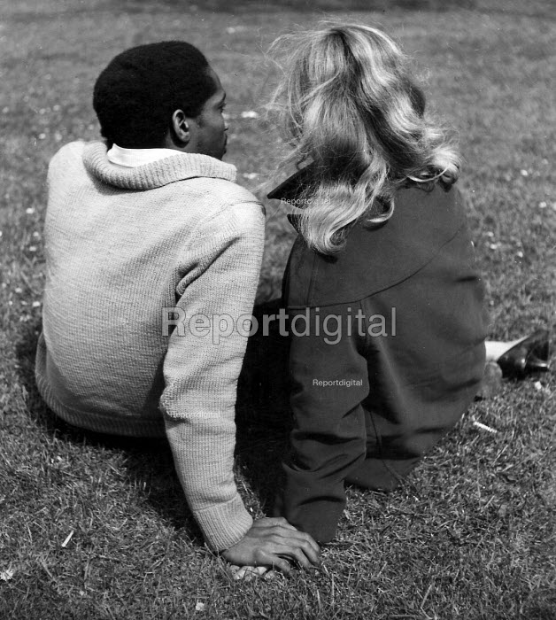 Reportage photo of Black and white couple holding hands in a London