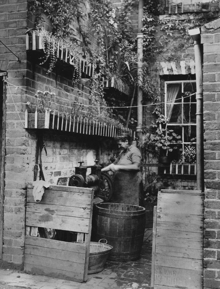 Backtoback houses, Birmingham a women doing the laundry in the back