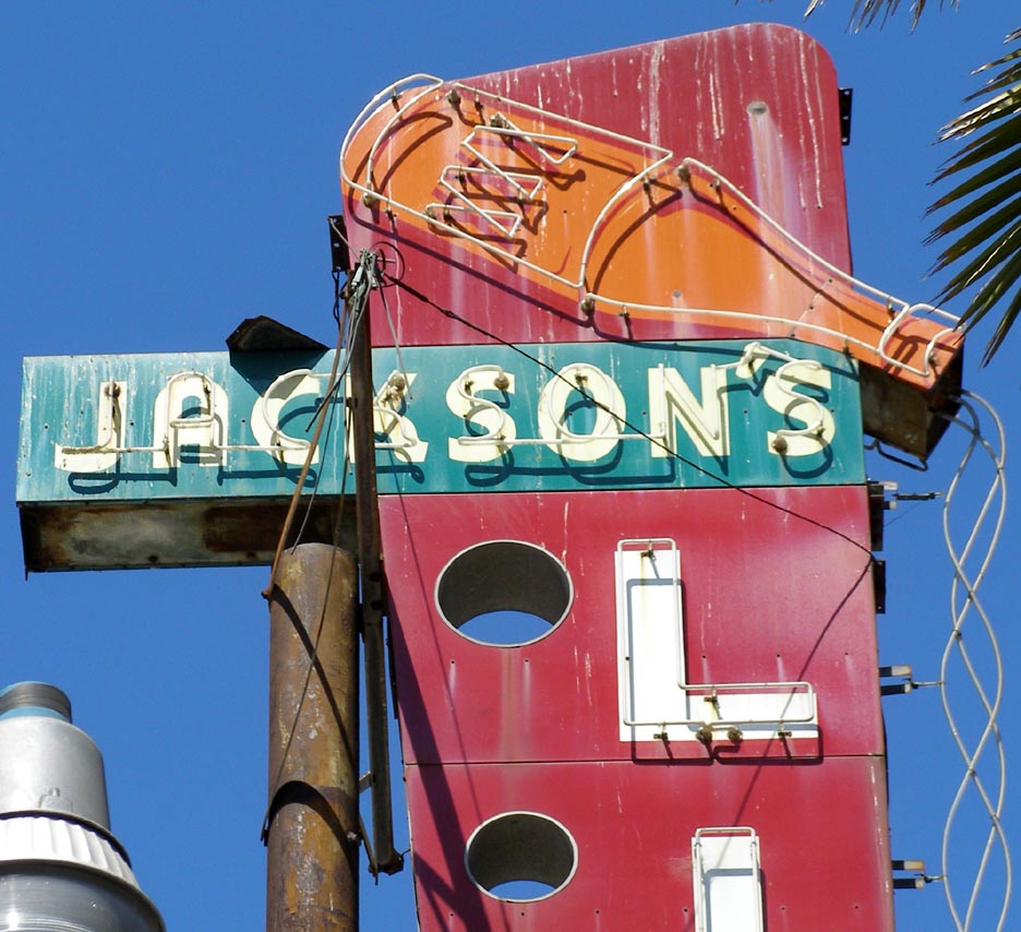 Ideal Cleaners opened in 1938. Their sign is lit at night. For more