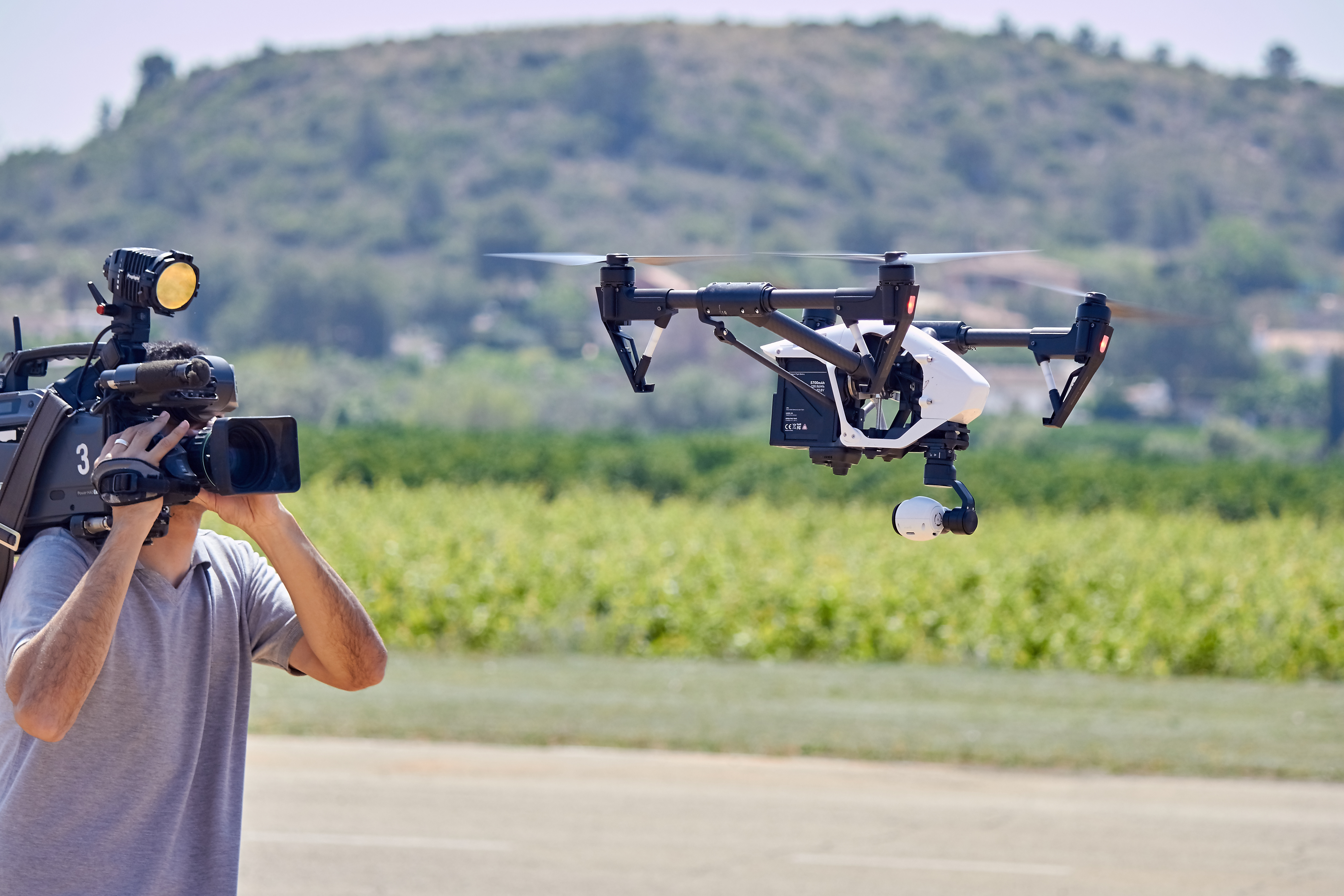 Camera men film the drone in flight Robotics Business Review