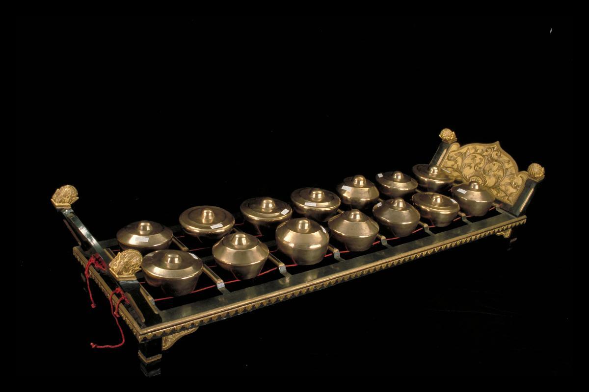 Gamelan instrument with kettle gongs on stand