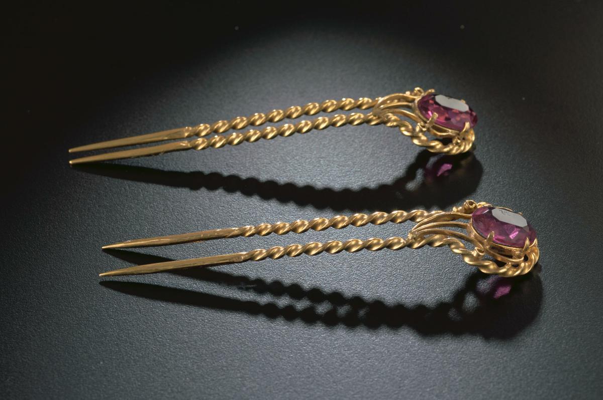 A pair of hair pins inset with red stones that belonged to a notable