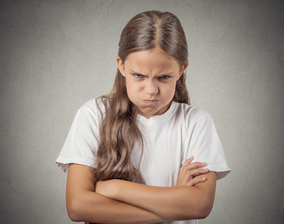 Headshot angry girl looking at you isolated on grey background School Mum