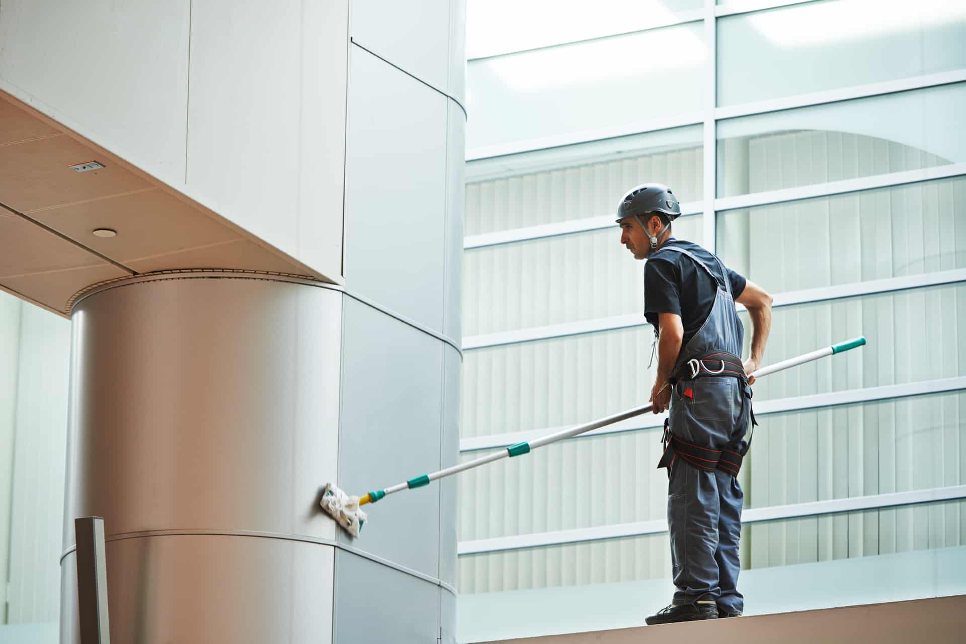 woman worker cleaning indoor window Service Autopilot