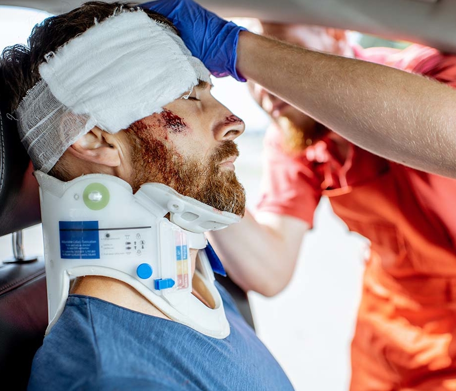 Medic providing emergency medical assistance after the road accident