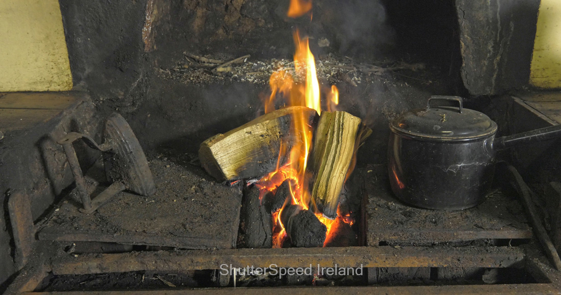 Sticks Blocks firewood and Peat Turf burning in an open fire from a Bog