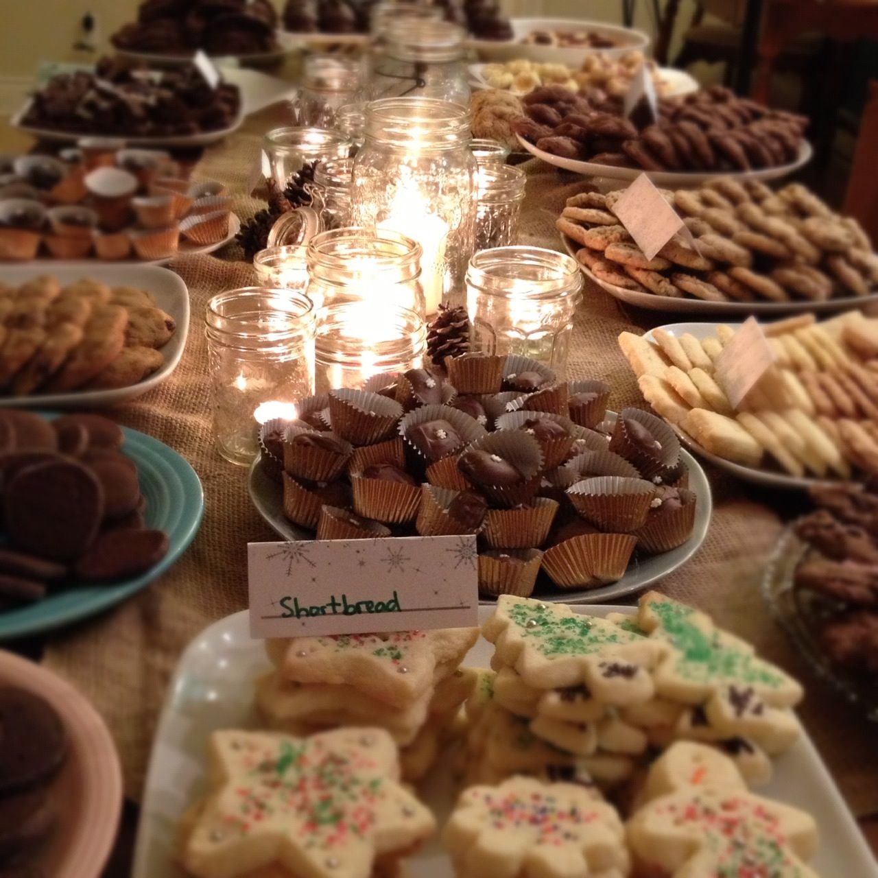 From the kitchen a simple centerpiece of tea lights in jam jars
