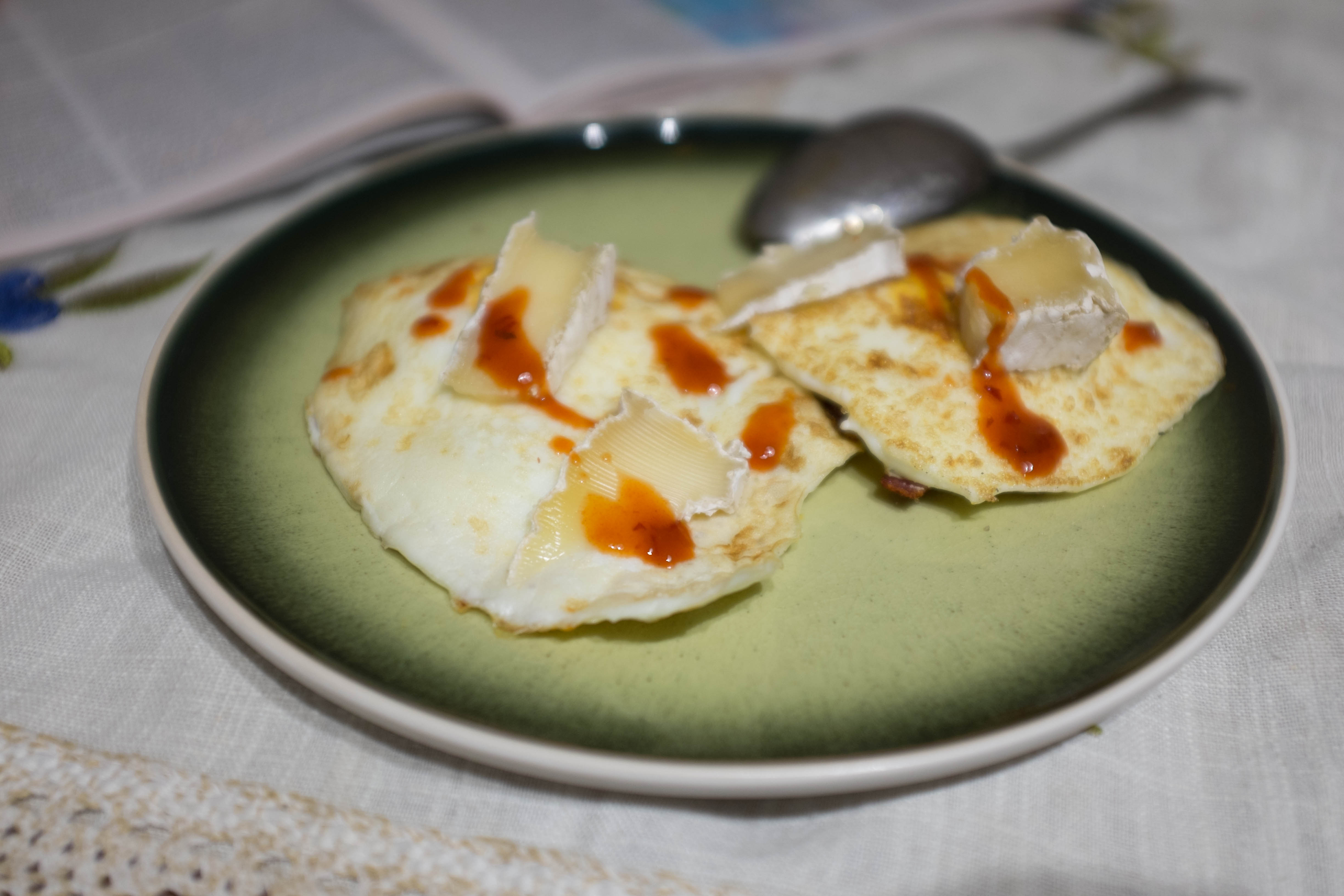 Eggs, cheese, and hot sauce a sibilant intake of breath