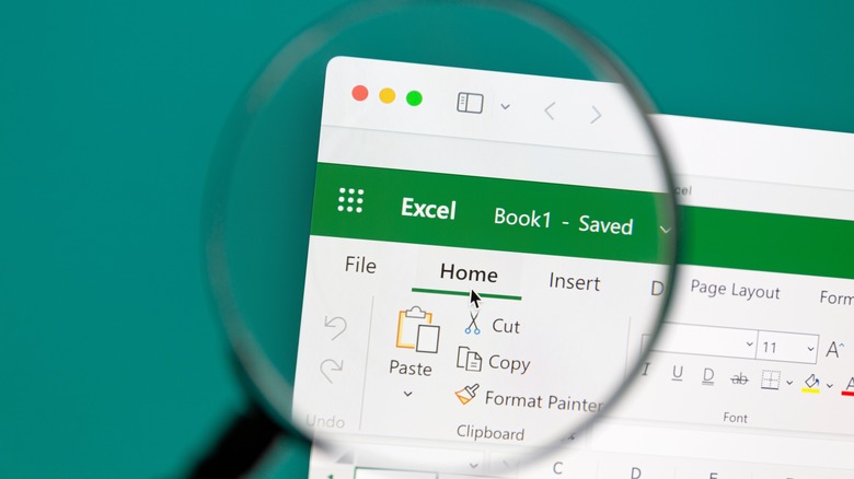 Magnifying glass highlighting Excel logo displayed on computer screen