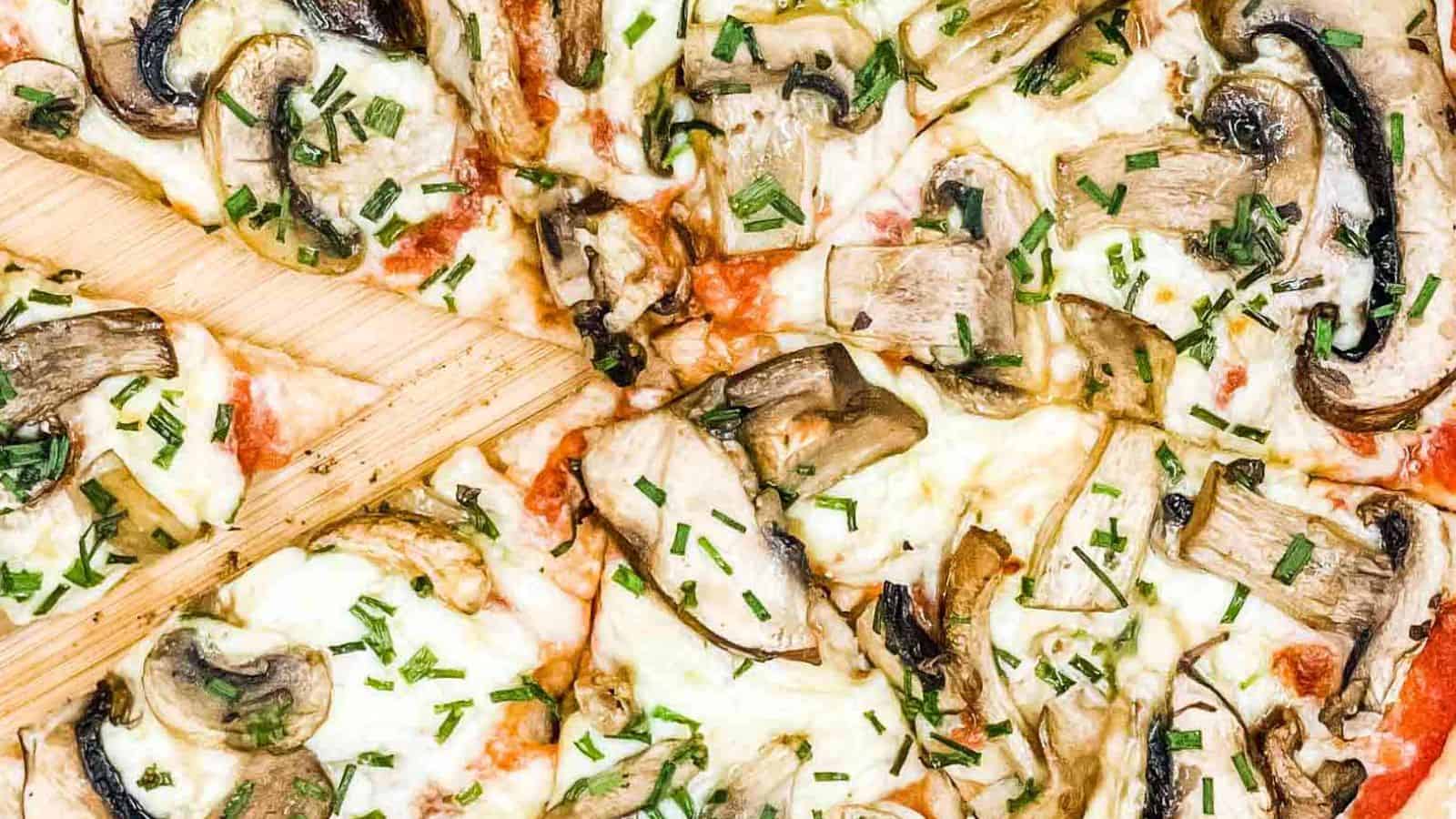 Mushroom pizza sliced and ready to eat.