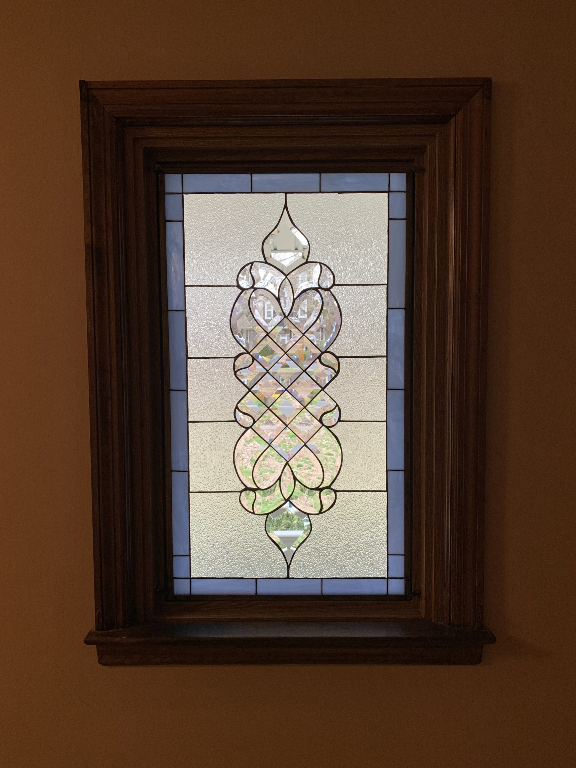The Laguna Stained & Beveled Window installed in wood frame