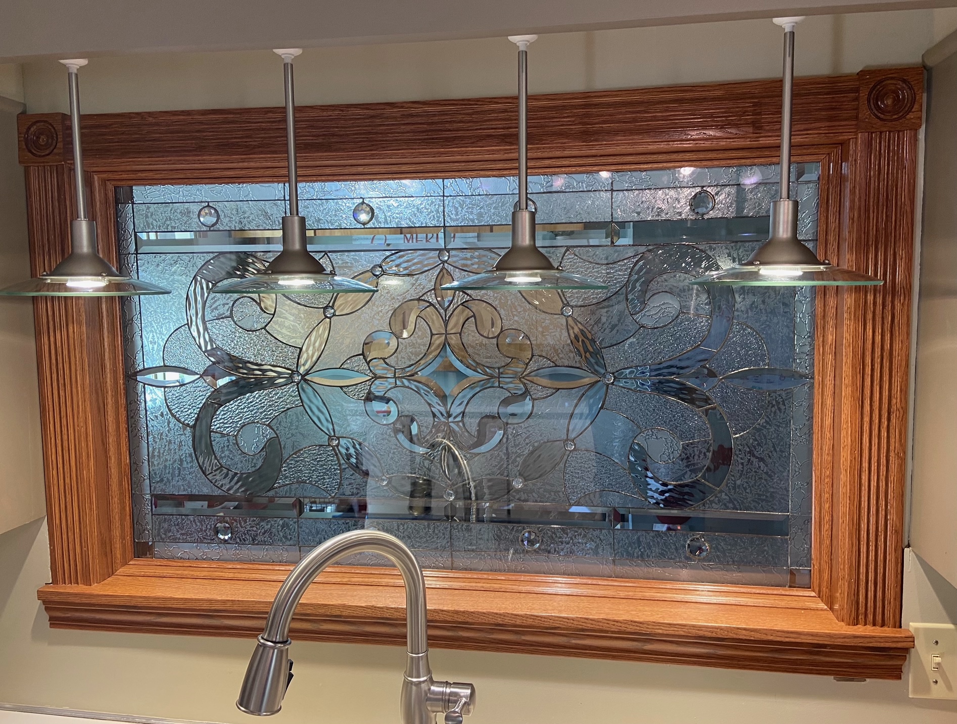 Clear and Beveled Stained Glass installed behind a kitchen sink