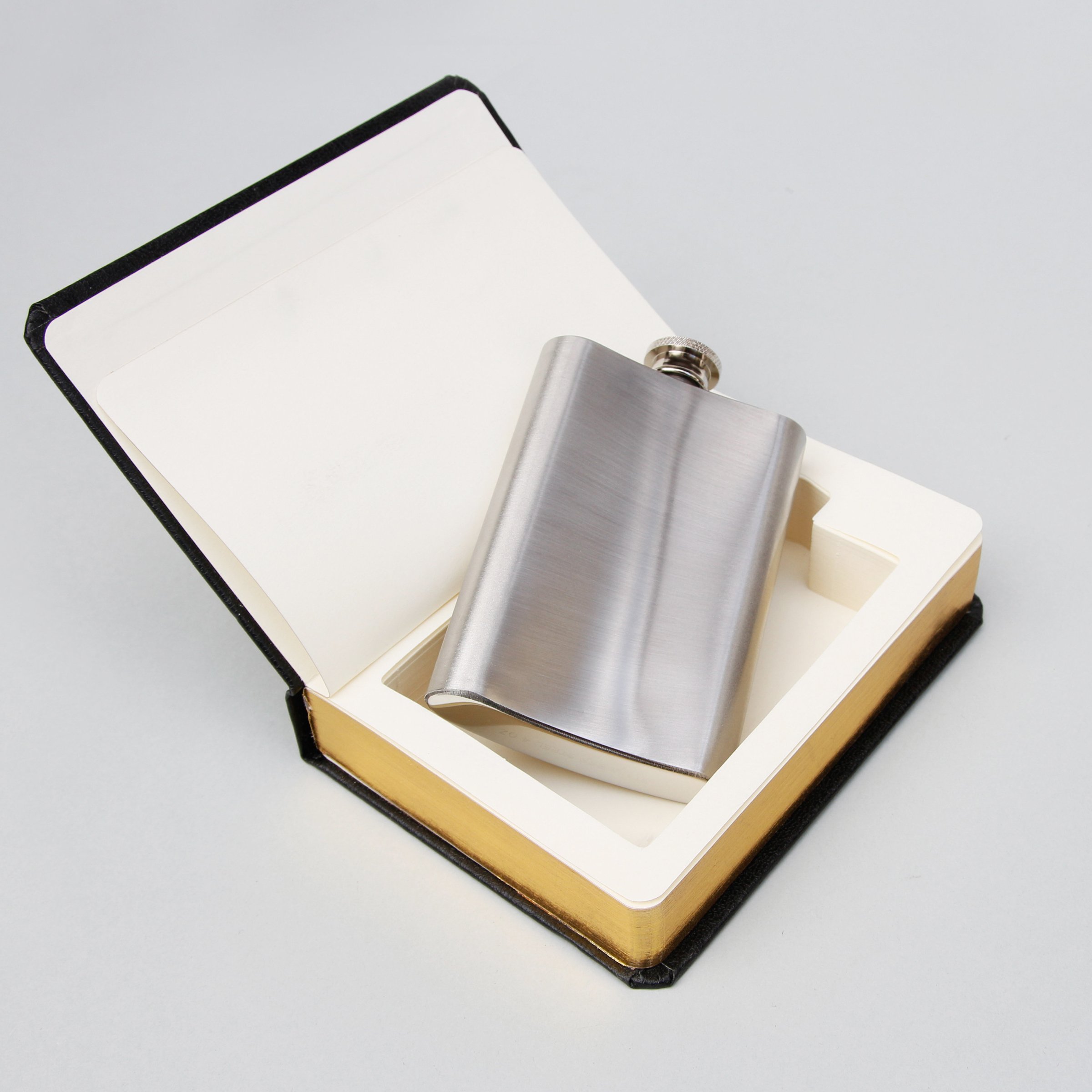 Flask In A Book Stash your drink inside the Good Book.