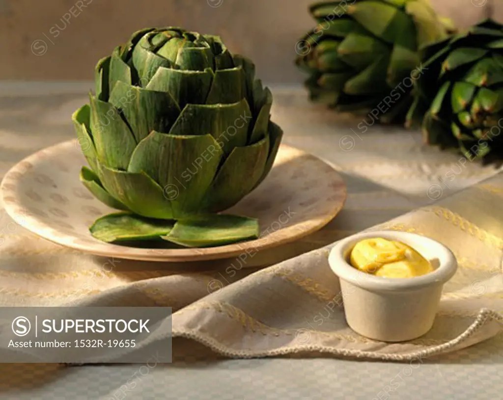An Artichoke with Mustard Mayonnaise Dip SuperStock
