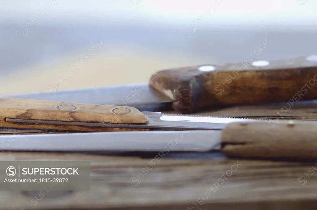 Knives on chopping board SuperStock