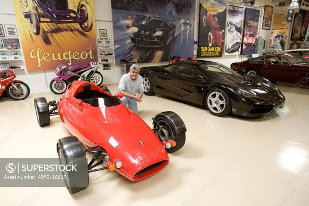 Jay Leno with some of the cars in his private garage. Shown here is the