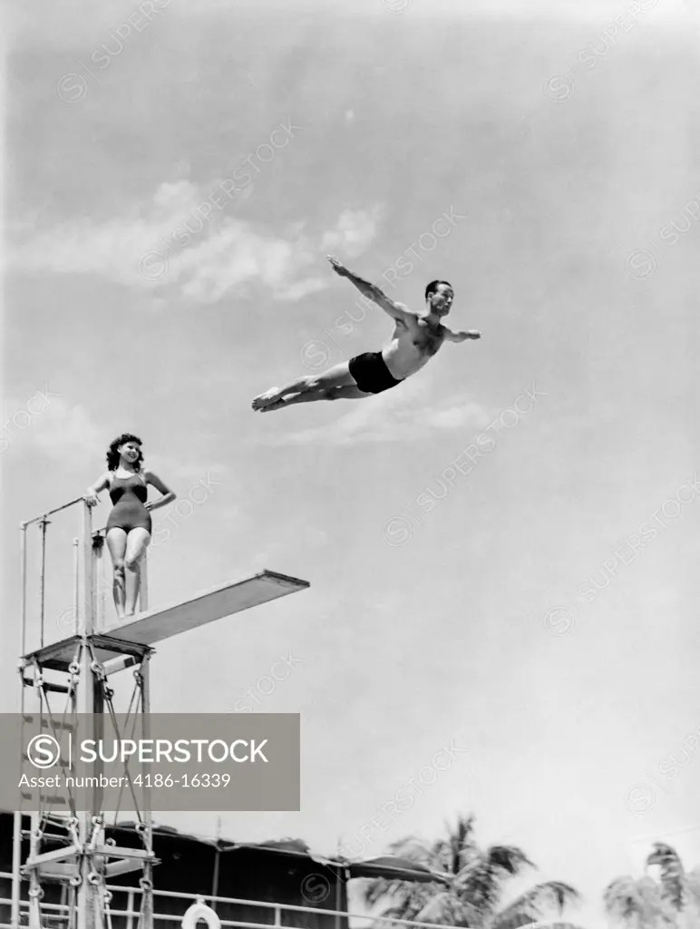 1940S Man Swan Diving Off High Diving Board Woman Watching SuperStock