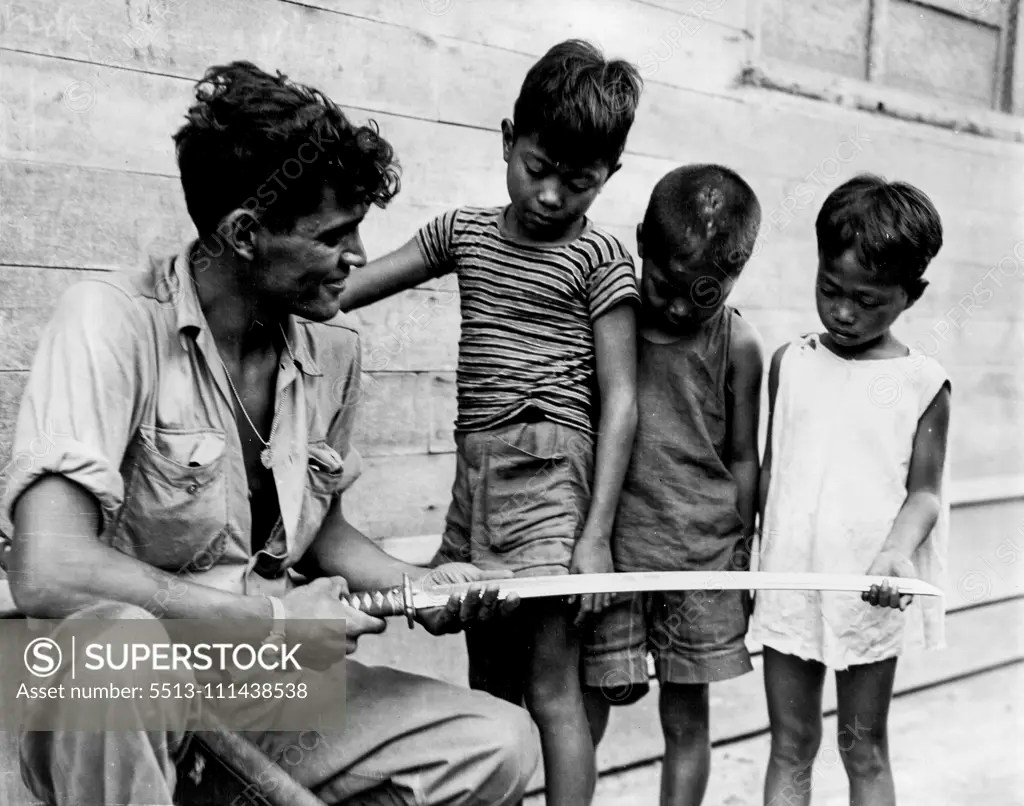Hero Worship Filipino children solemnly inspect a Samurai sword that