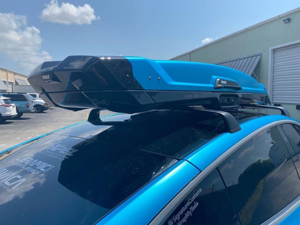 This custom wrapped Tesla Model Y with the roof racks and matching