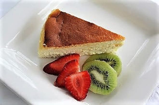 Luscious Ricotta Cheesecake made with homemade ricotta Slice of Ricotta Cheesecake with Homemade Ricotta on a white plate