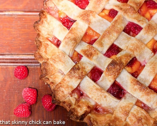 Lattice Topped Peach Raspberry Pie - a magnificent fruit combination in a buttery pastry crust. An outstanding summer fruit pie! Overhead view of Lattice Topped Peach Raspberry Pie