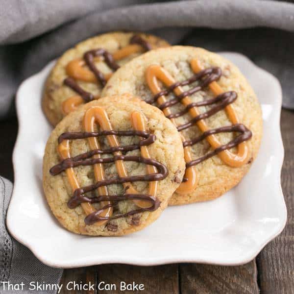 Toffee Cookies - Chock full of toffee and walnuts and drizzled with caramel and chocolate! Toffee Cookies on a square white plate