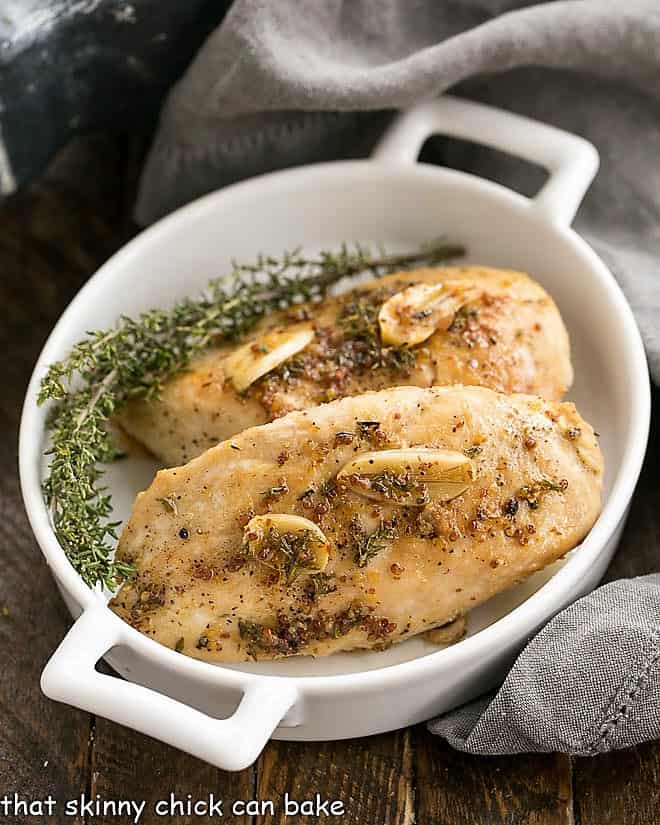 Maple Mustard Glazed Chicken - An easy, family friendly meal that is ready in about 45 minutes! Maple Mustard Glazed Chicken Breasts in a white dish with handles